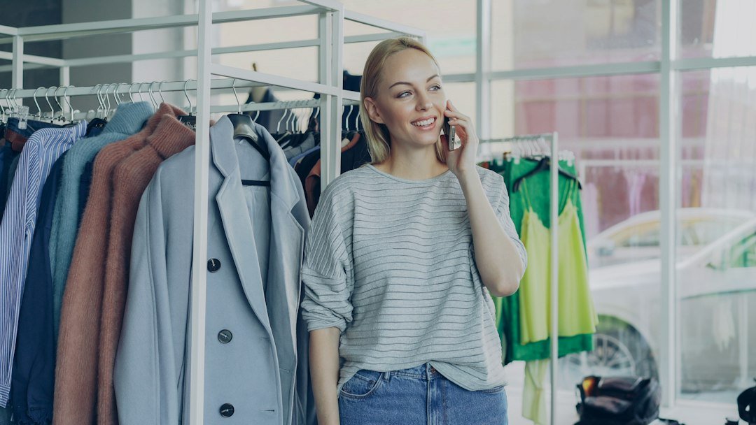 Boutique owner checking a customer message, illustrating social media for local businesses.